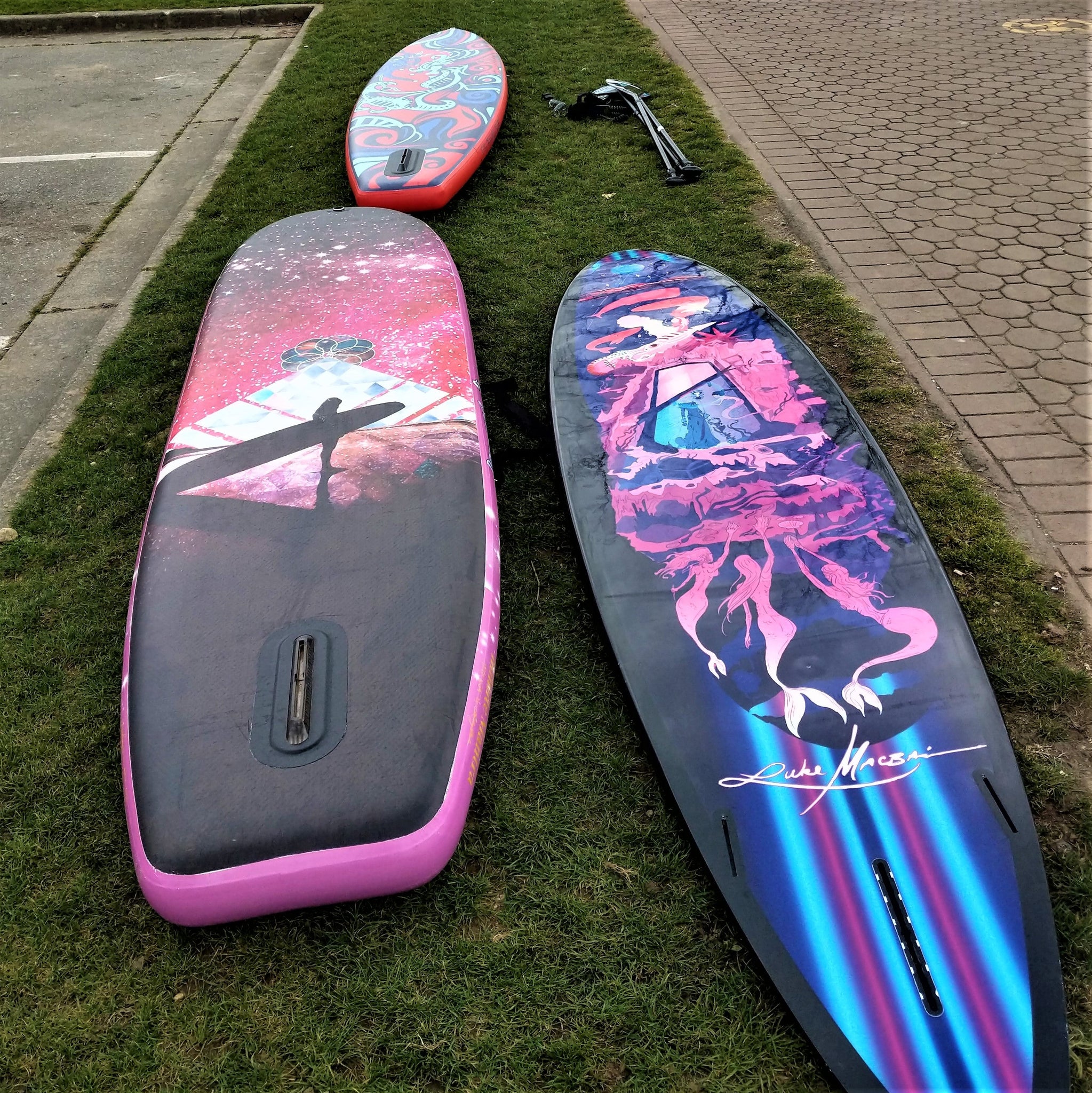 Two paddle boards with the finbox pointing upwards.