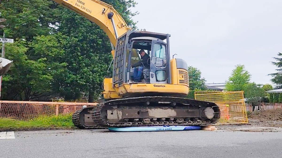 Sea Gods’ Inflatable SUP Manufacturing Standards - digger driving over our paddleboard
